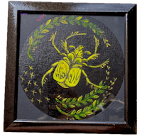 a painting of a yellow beetle in a black frame